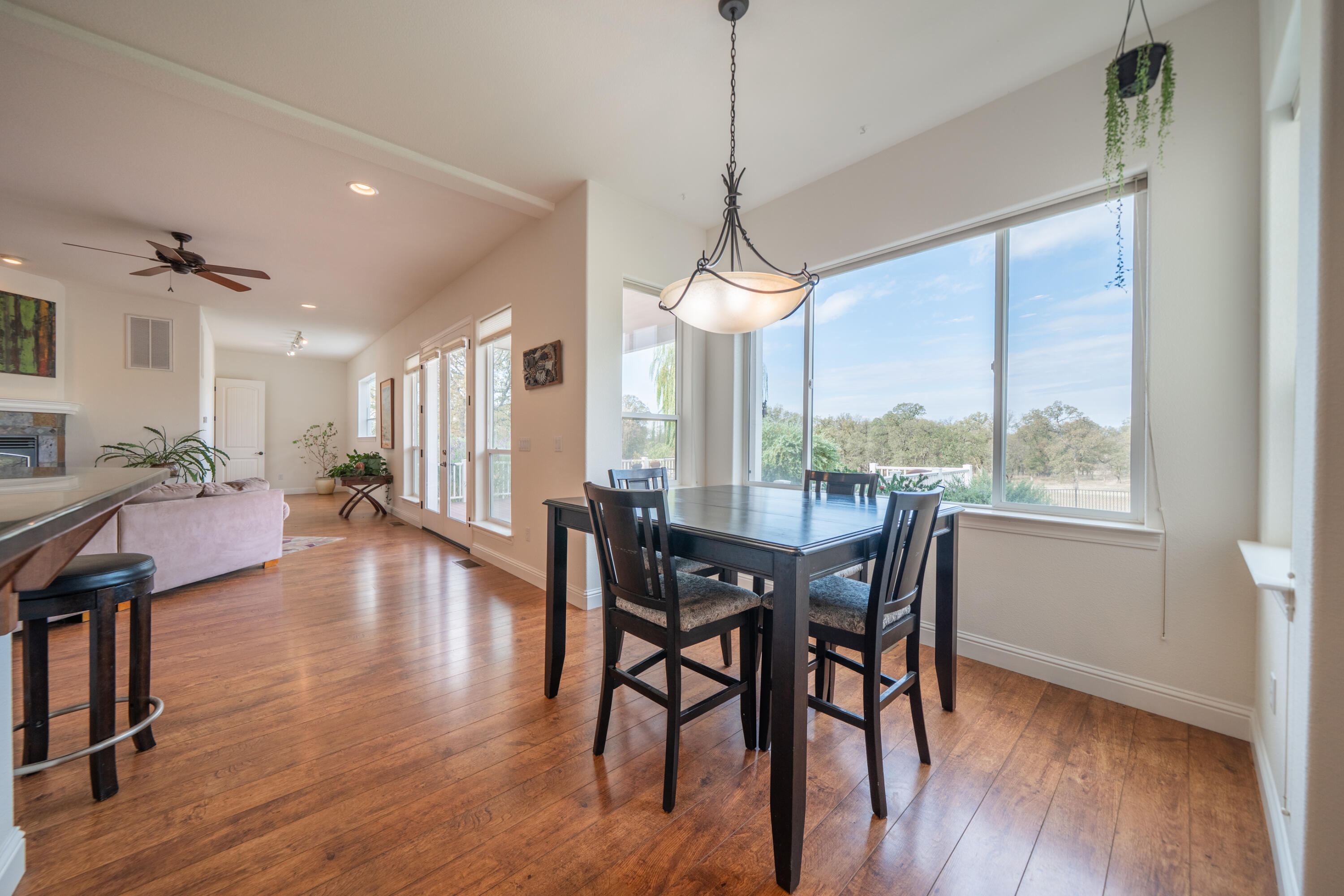 8180 Whispering Oaks Road Redding, CA 96002 - Photo 23 of 100 a view of a dining room with furniture window and wooden floor