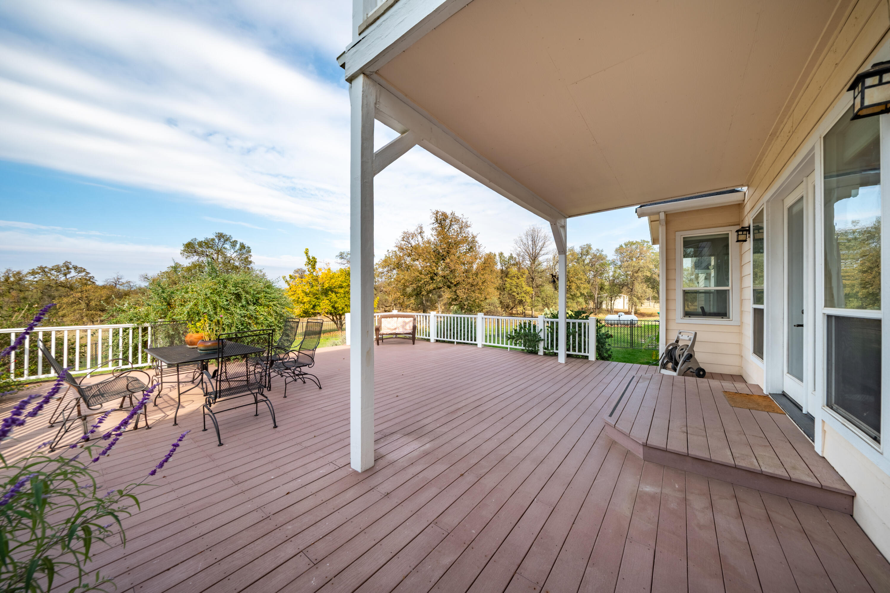 8180 Whispering Oaks Road Redding, CA 96002 - Photo 54 of 100 a view of a patio with wooden floor table and chairs