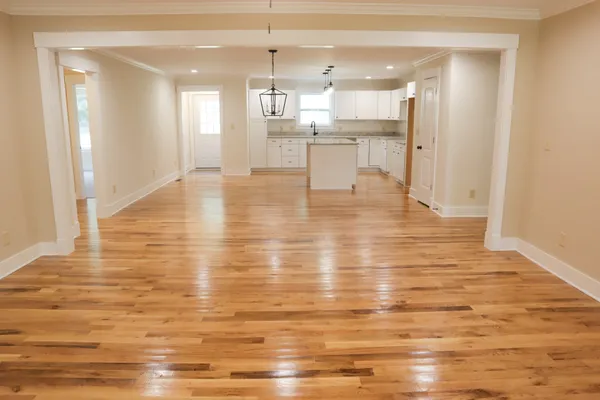 a large kitchen with kitchen island a sink stainless steel appliances and cabinets