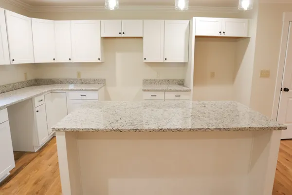 a bathroom with a granite countertop sink mirror and shower
