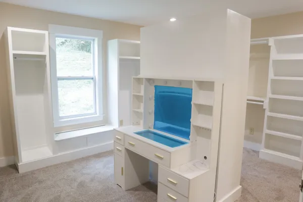 a view of cabinets and bathroom with a sink