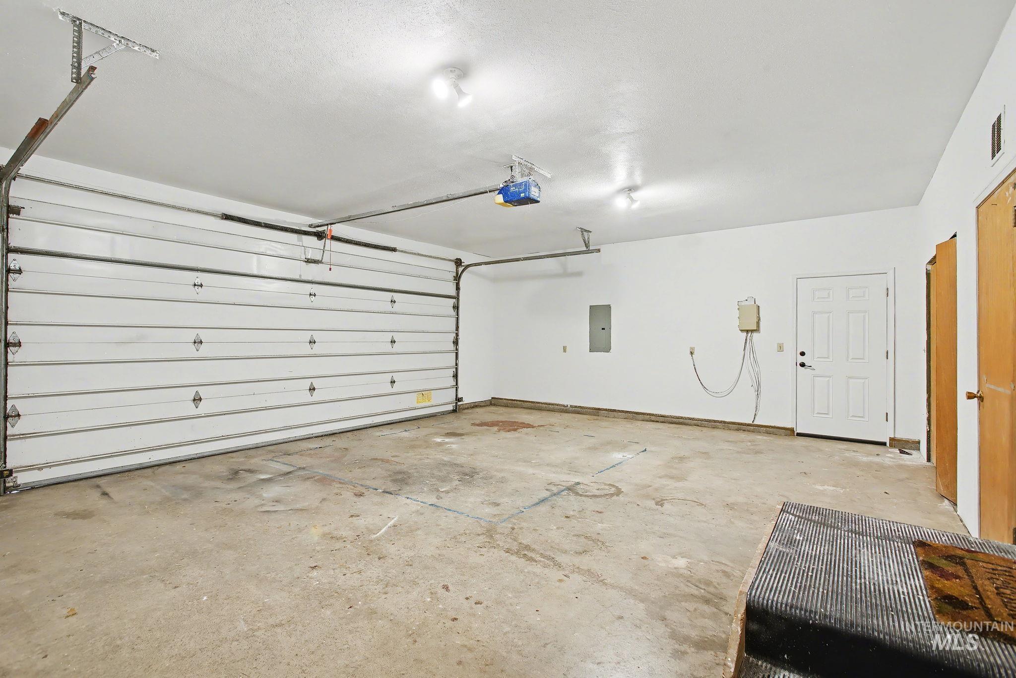 2242 Chukar Lane Clarkston, WA 99403 - Photo 31 of 41 Garage featuring electric panel and a garage door opener