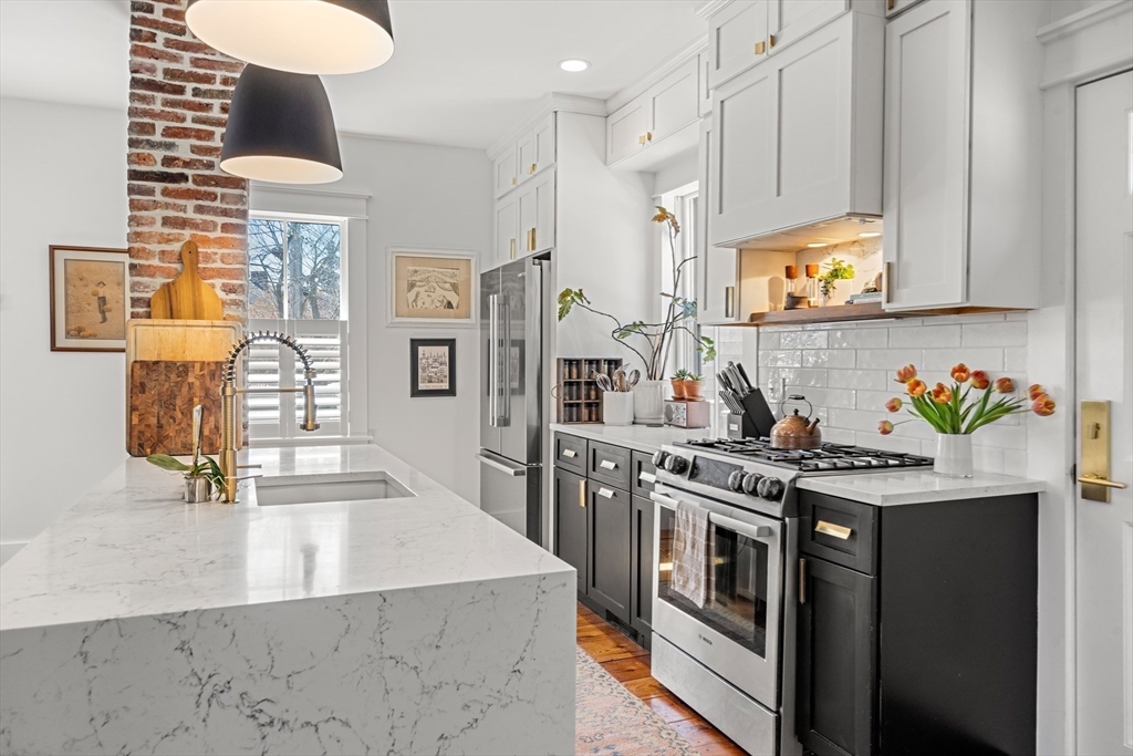 1 Gregory Street Marblehead, MA 01945 - Photo 15 of 42 a kitchen with stainless steel appliances granite countertop a stove a sink and a refrigerator