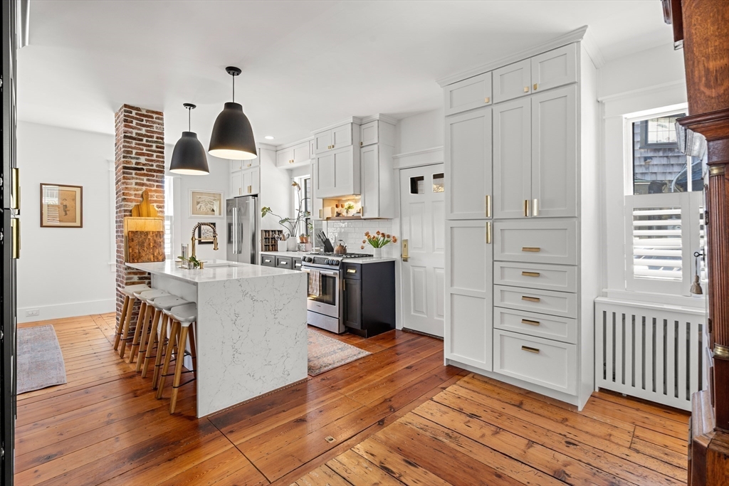 1 Gregory Street Marblehead, MA 01945 - Photo 16 of 42 a kitchen with a refrigerator a stove and a wooden floor