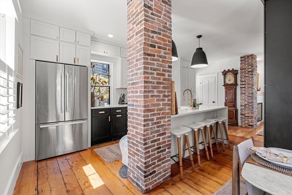 1 Gregory Street Marblehead, MA 01945 - Photo 17 of 42 a kitchen with stainless steel appliances a refrigerator and a wooden floor