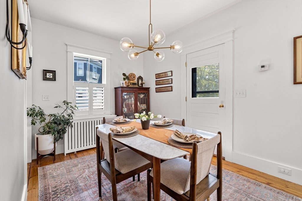 1 Gregory Street Marblehead, MA 01945 - Photo 18 of 42 a dining room with furniture potted plants and wooden floor