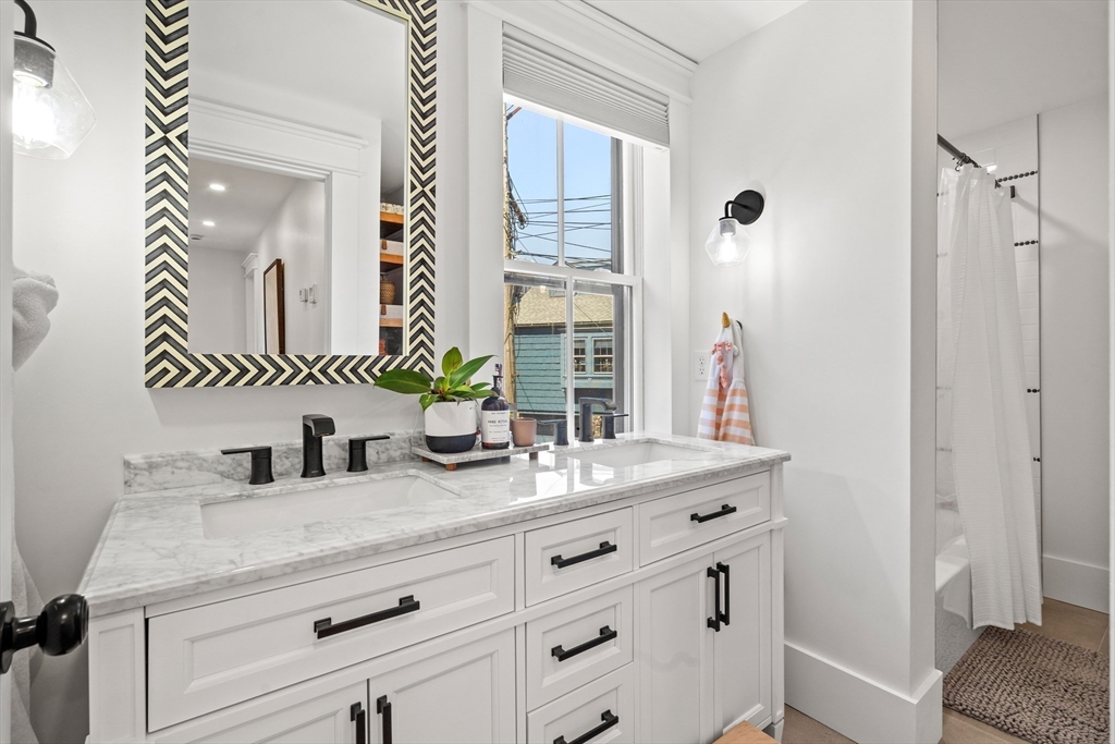 1 Gregory Street Marblehead, MA 01945 - Photo 24 of 42 a bathroom with a granite countertop sink and a mirror
