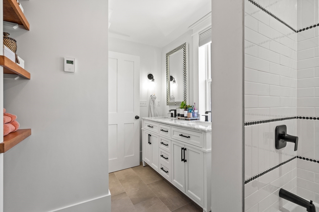 1 Gregory Street Marblehead, MA 01945 - Photo 25 of 42 a bathroom with a double vanity sink and mirror