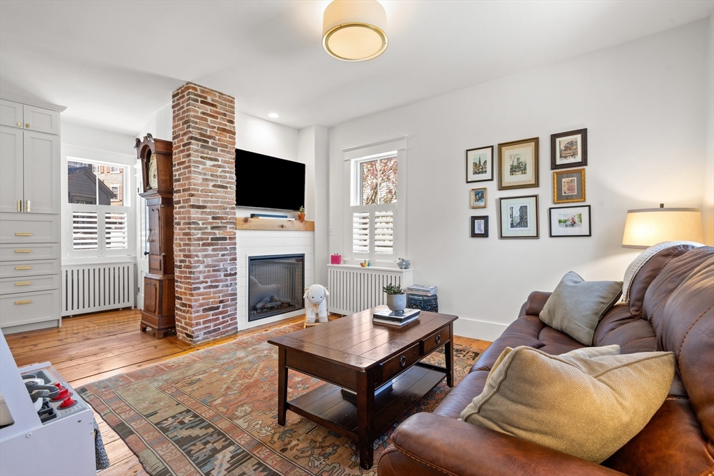 1 Gregory Street Marblehead, MA 01945 - Photo 10 of 42 a living room with furniture a flat screen tv and a fireplace