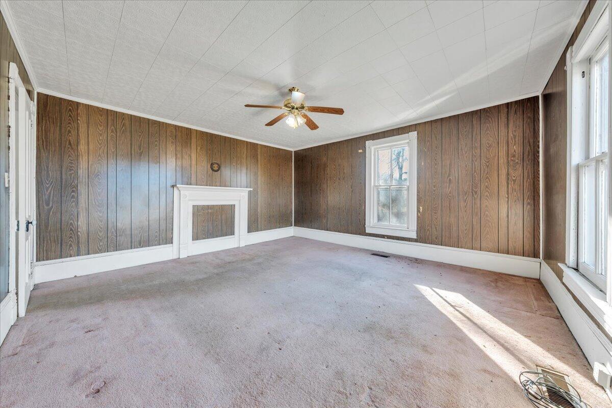 5402 Roanoke Road Troutville, VA 24175 - Photo 12 of 54 an empty room with windows and a fireplace