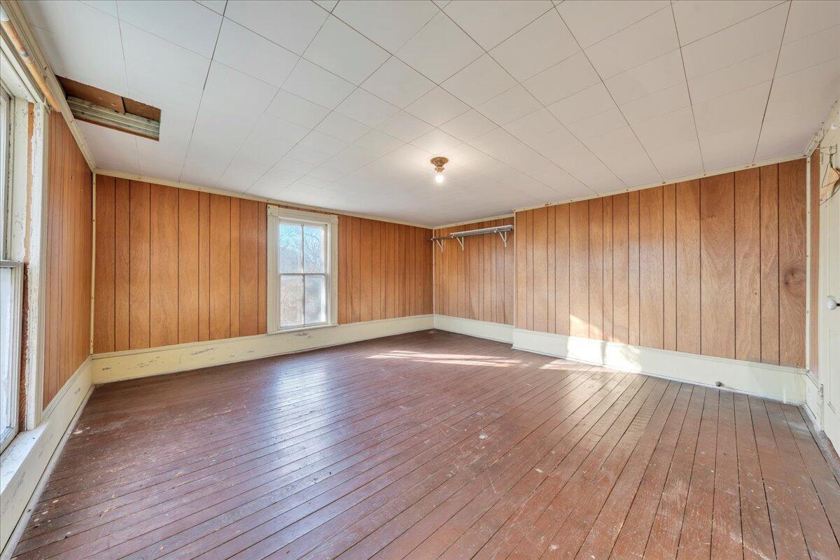 5402 Roanoke Road Troutville, VA 24175 - Photo 26 of 54 an empty room with wooden floor and windows