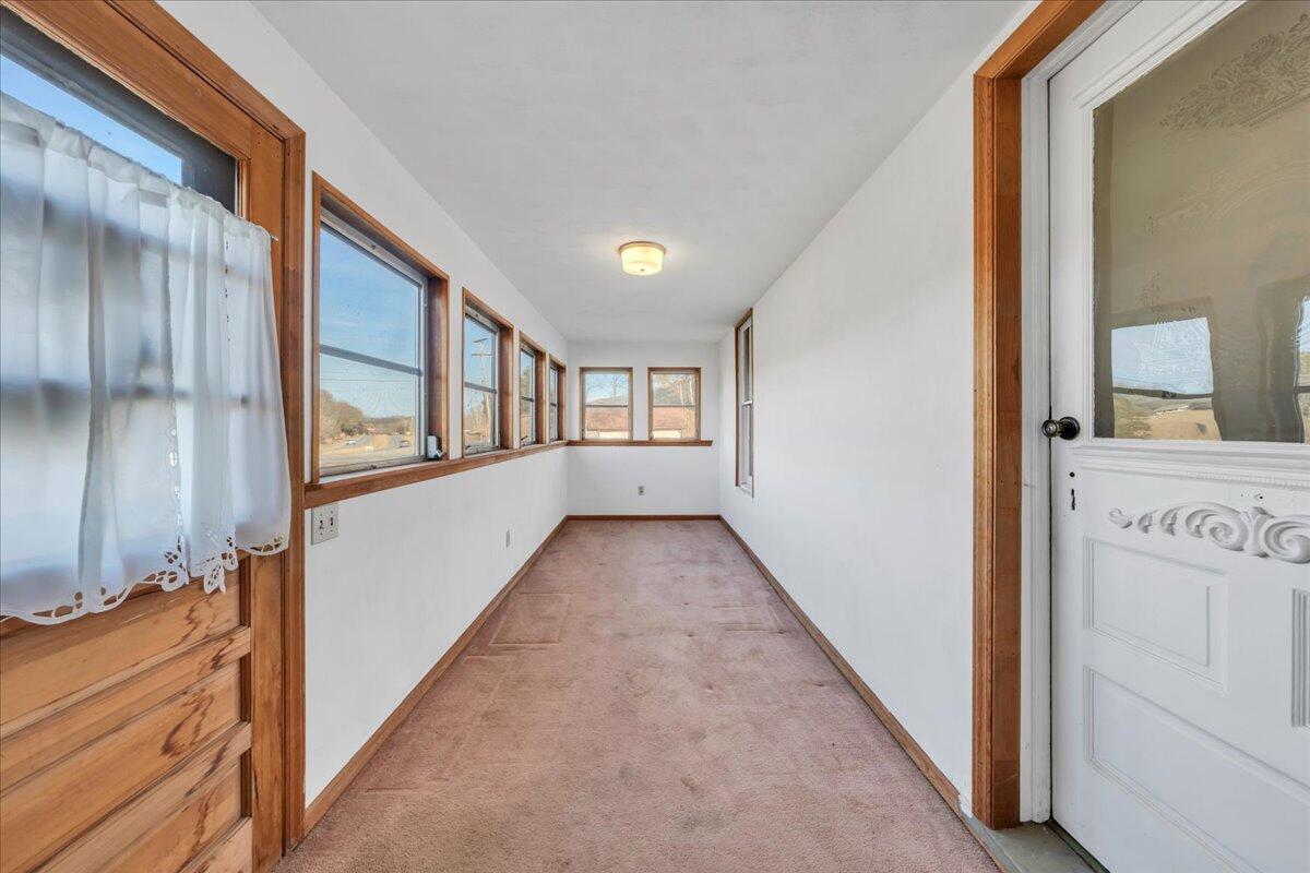 5402 Roanoke Road Troutville, VA 24175 - Photo 6 of 54 a view of a hallway to an empty room with wooden floor and windows