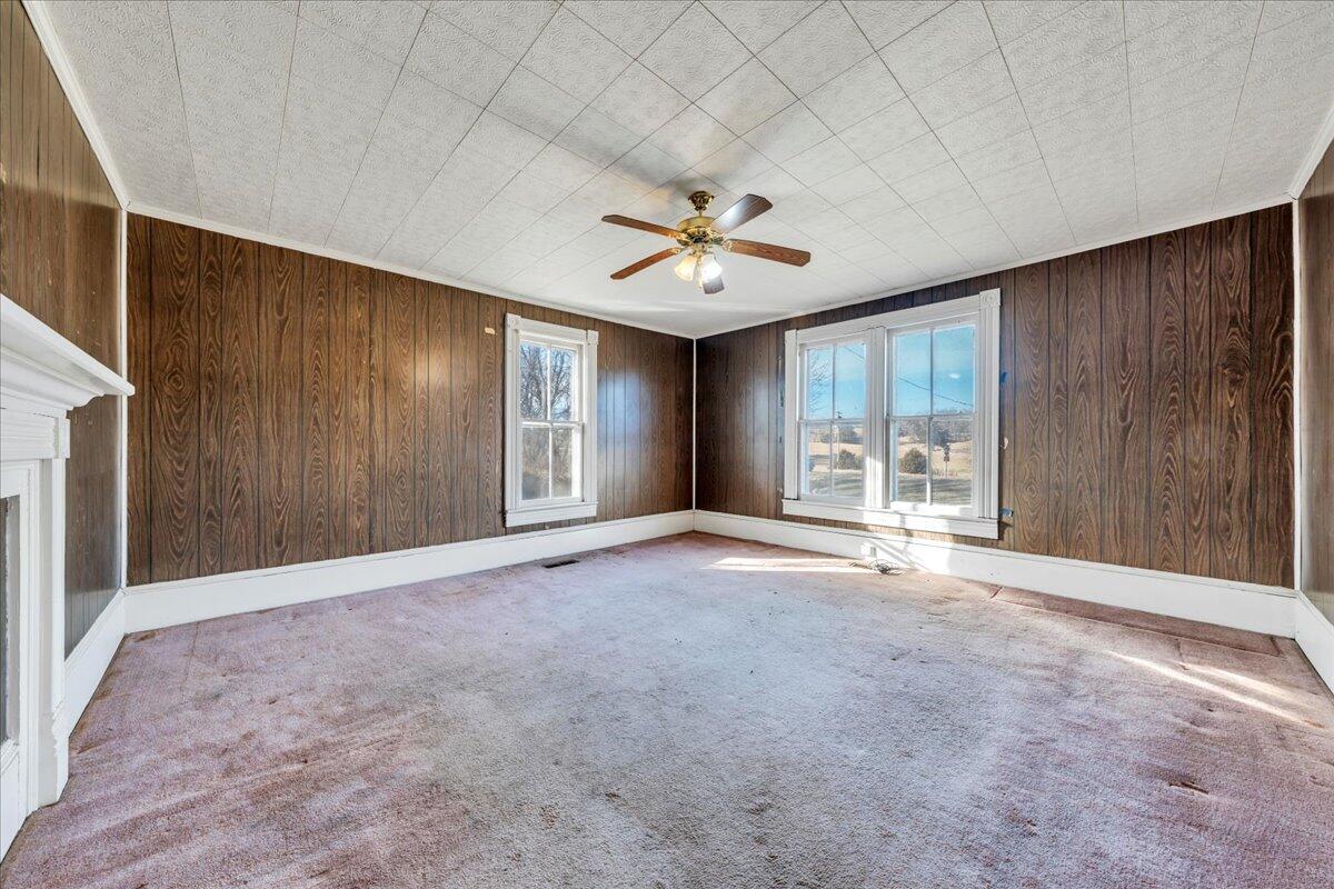 5402 Roanoke Road Troutville, VA 24175 - Photo 10 of 54 an empty room with windows and a chandelier fan