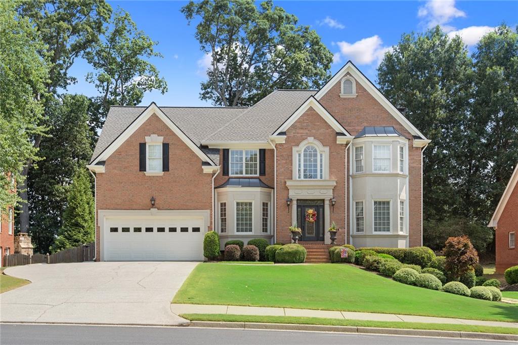 5445 Preserve Circle Alpharetta, GA 30005 - Photo 1 of 1 a view of a white house with a big yard and large trees