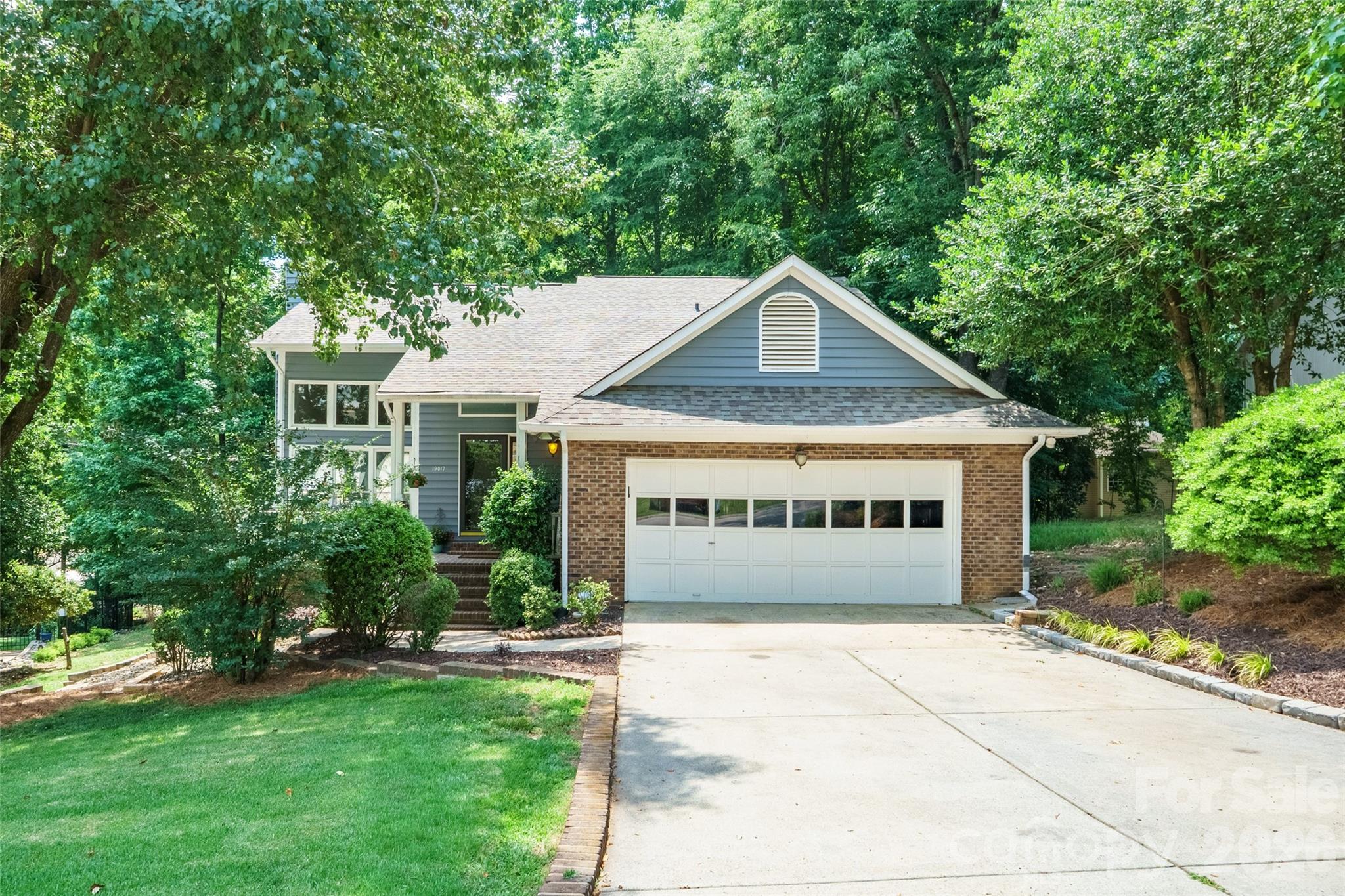 a front view of a house with garden