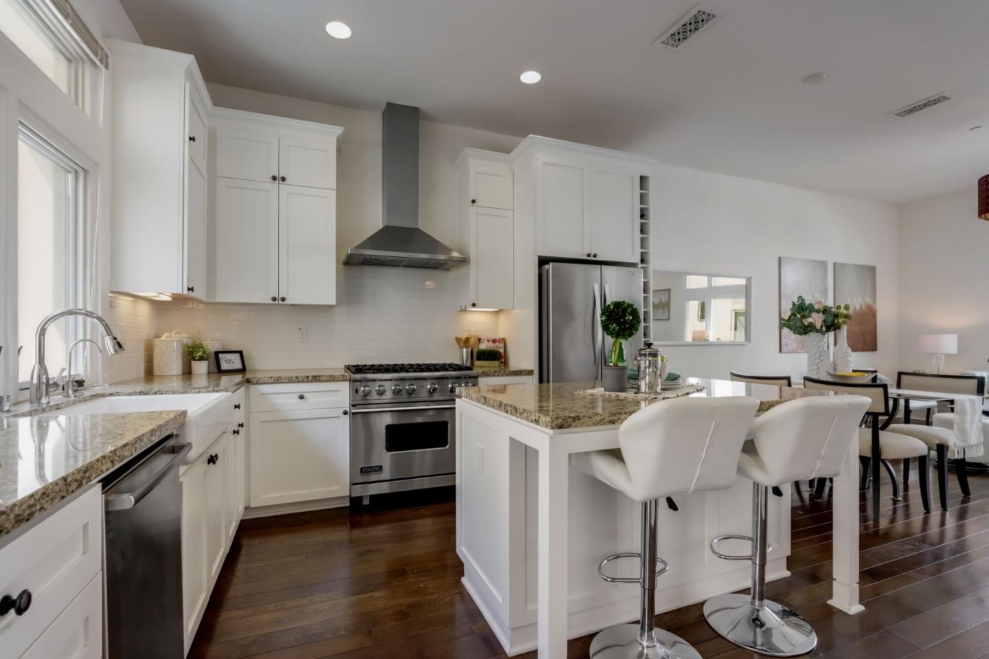 612 Allerton Loop Campbell, CA 95008 - Photo 8 of 38 a kitchen with stainless steel appliances a sink stove refrigerator and cabinets