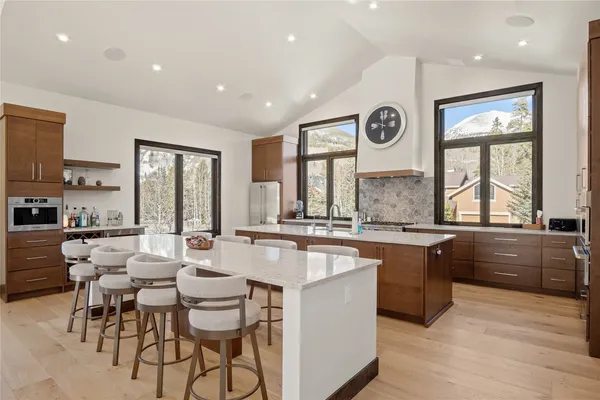 a kitchen with counter top space a sink and appliances