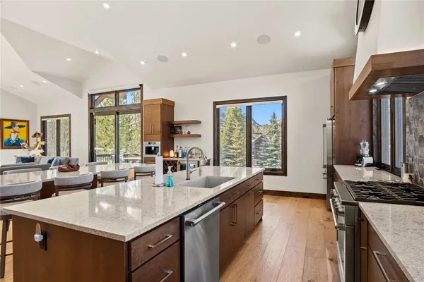 a kitchen with counter top space a sink stove and cabinets