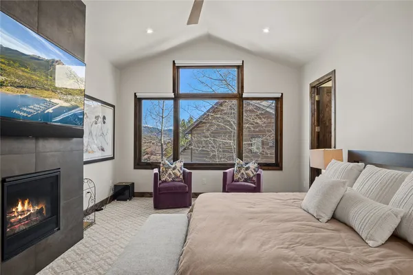 a bedroom with a bed and a fireplace