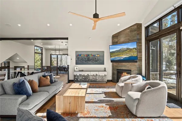 a living room with furniture large window and a fireplace