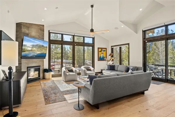 a living room with furniture large windows and a flat screen tv