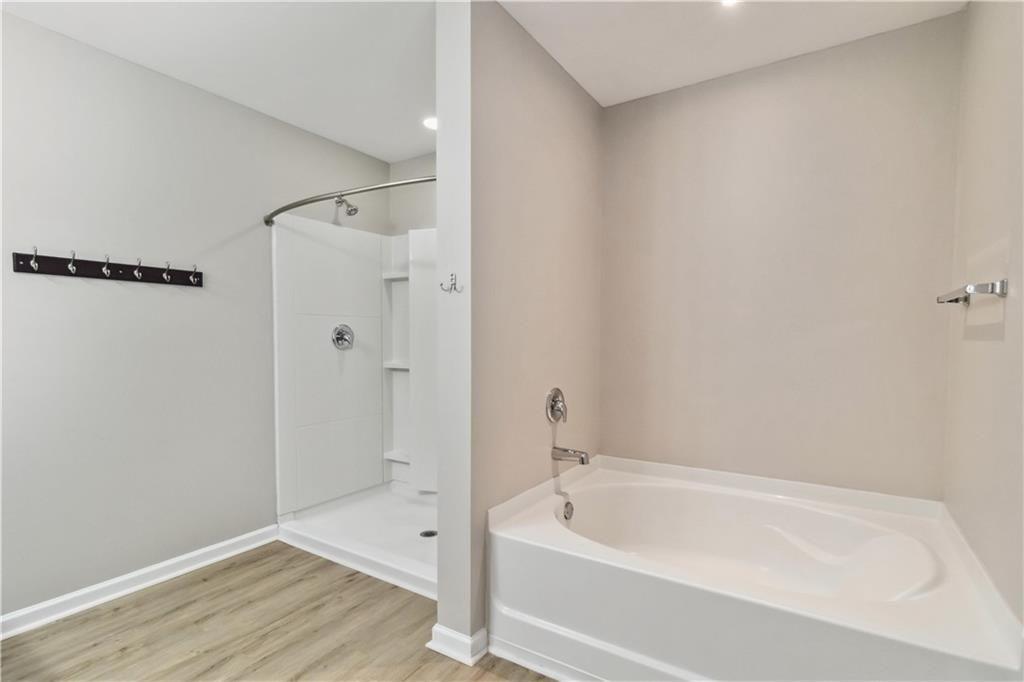 100 Heritage Club Circle Dallas, GA 30132 - Photo 11 of 26 a bathroom with a bathtub and a shower