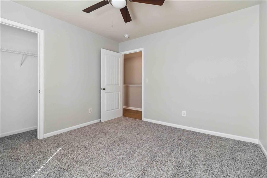 100 Heritage Club Circle Dallas, GA 30132 - Photo 12 of 26 an empty room with chandelier fan