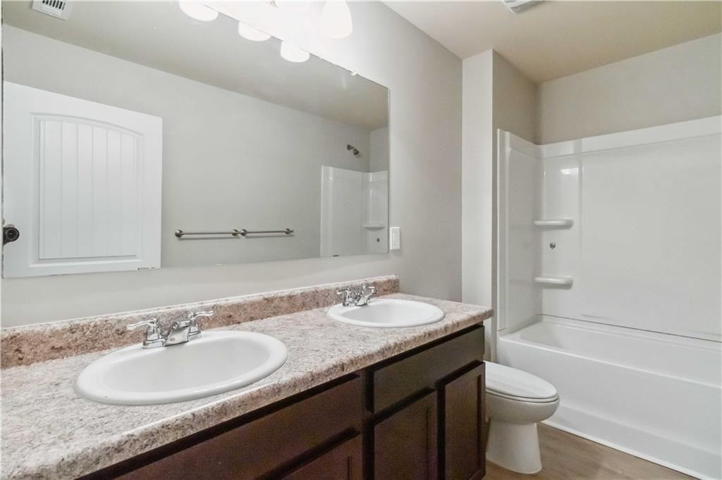 100 Heritage Club Circle Dallas, GA 30132 - Photo 14 of 26 a bathroom with a granite countertop sink toilet and shower