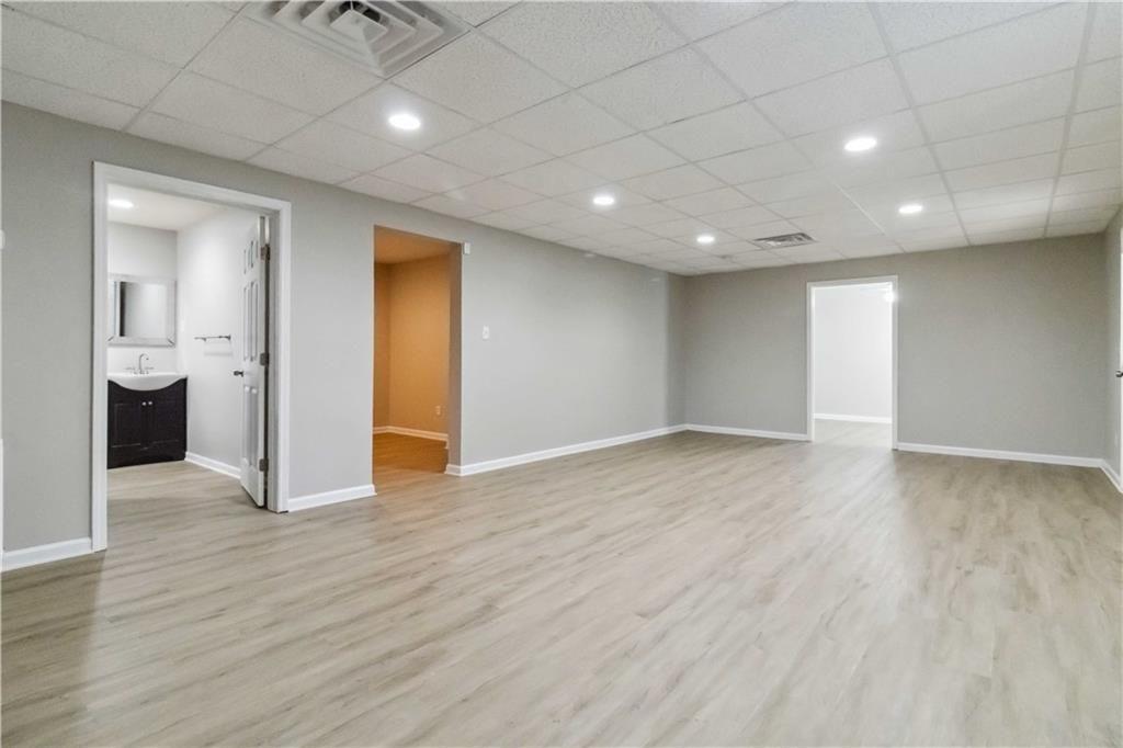 100 Heritage Club Circle Dallas, GA 30132 - Photo 16 of 26 a view of an empty room with wooden floor and a bathroom