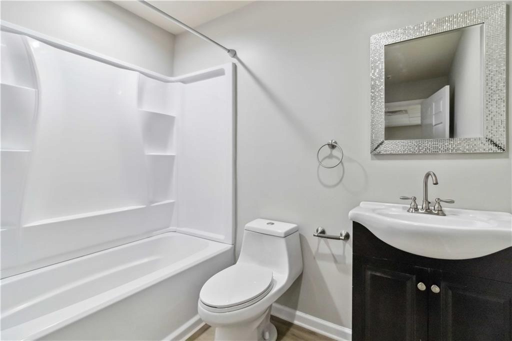 100 Heritage Club Circle Dallas, GA 30132 - Photo 17 of 26 a bathroom with a sink toilet and shower