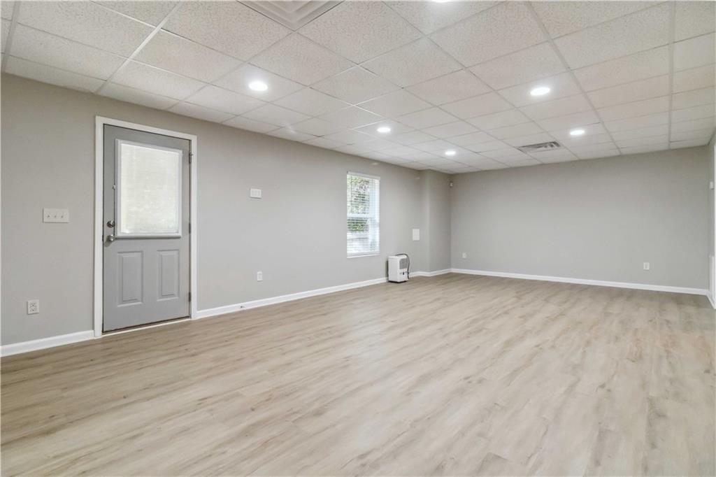 100 Heritage Club Circle Dallas, GA 30132 - Photo 21 of 26 an empty room with wooden floor and windows with curtains