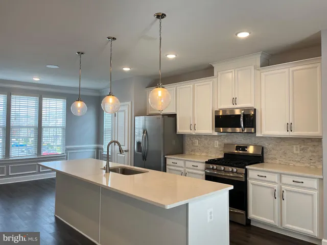 a kitchen with cabinets and stainless steel appliances