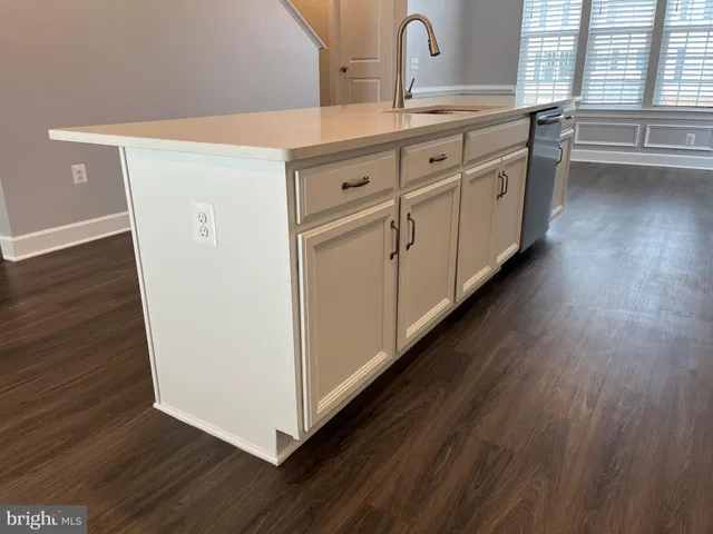 a kitchen with stainless steel appliances and refrigerator