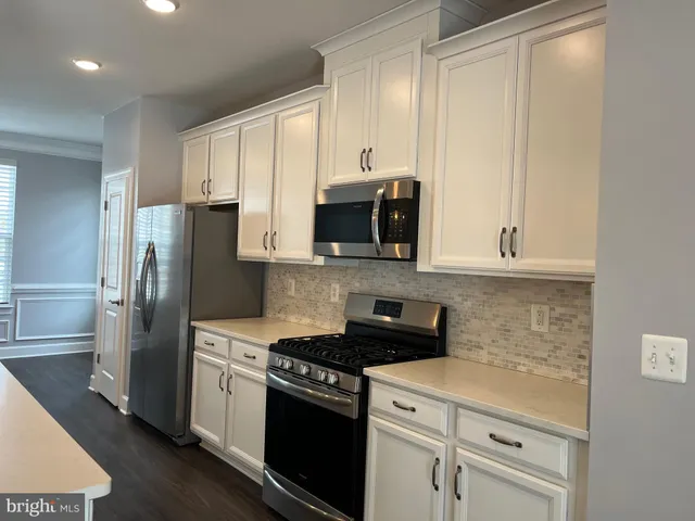 a kitchen with a sink a stove and refrigerator
