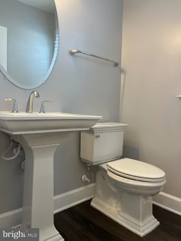 a white toilet sitting next to a bath tub