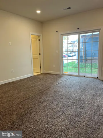 a view of an empty room with a sliding door