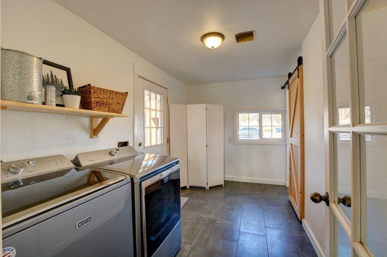 11955 Perry Road White City, OR 97503 - Photo 20 of 32 a kitchen that has a sink wooden floor and a window