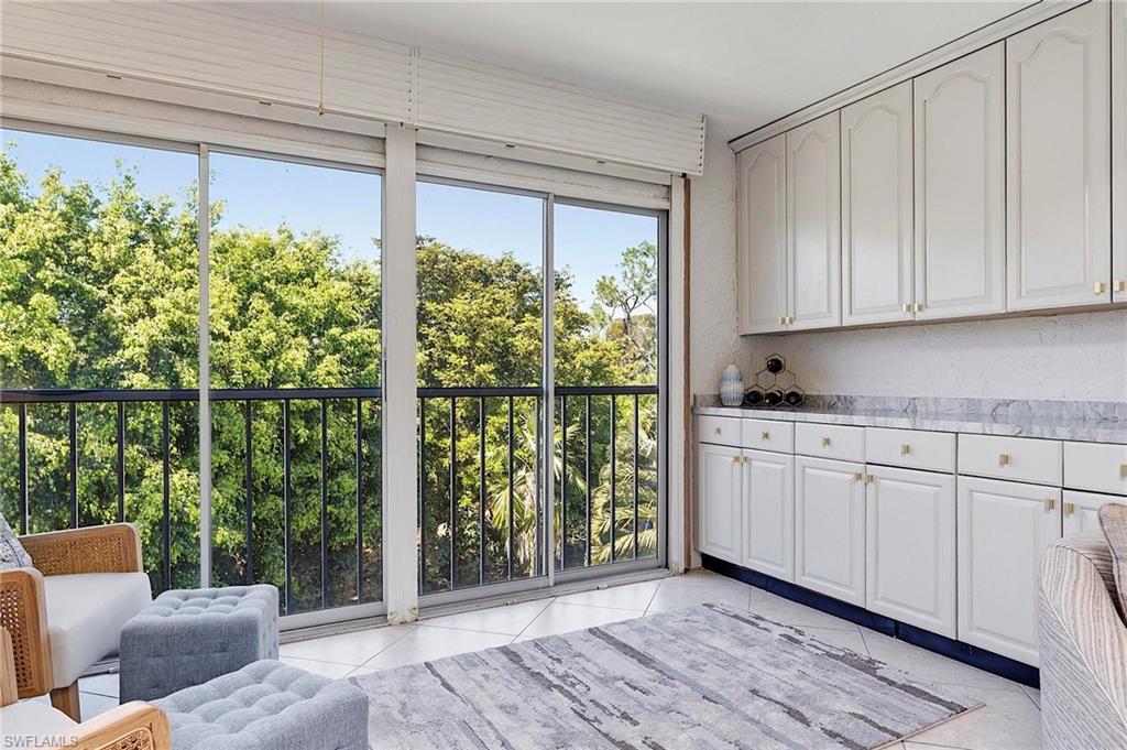 1001 Foxfire Lane, Unit 307 Naples, FL 34104 - Photo 12 of 23 a view of a kitchen with furniture and staircase