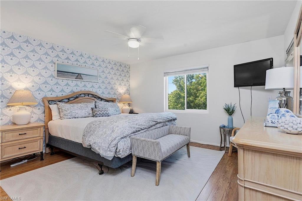 1001 Foxfire Lane, Unit 307 Naples, FL 34104 - Photo 14 of 23 a bedroom with a bed and a window