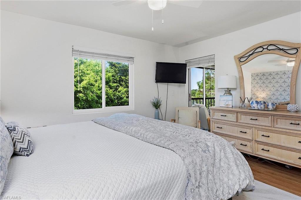 1001 Foxfire Lane, Unit 307 Naples, FL 34104 - Photo 15 of 23 a bedroom with a bed and a flat screen tv
