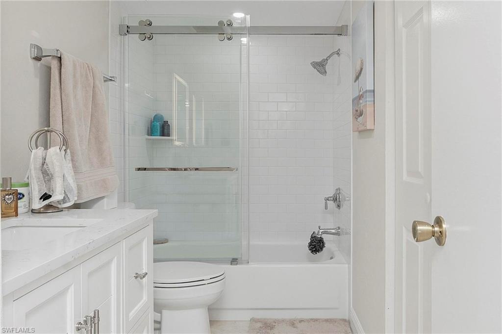1001 Foxfire Lane, Unit 307 Naples, FL 34104 - Photo 17 of 23 a bathroom with a sink toilet and shower