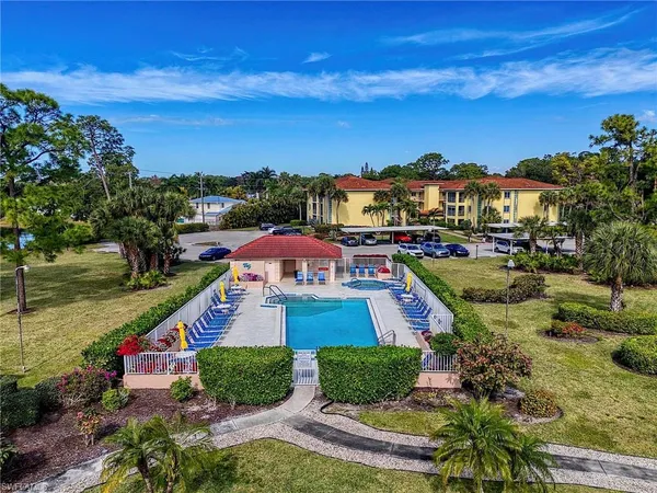 a aerial view of a house with a yard basket ball court and outdoor seating