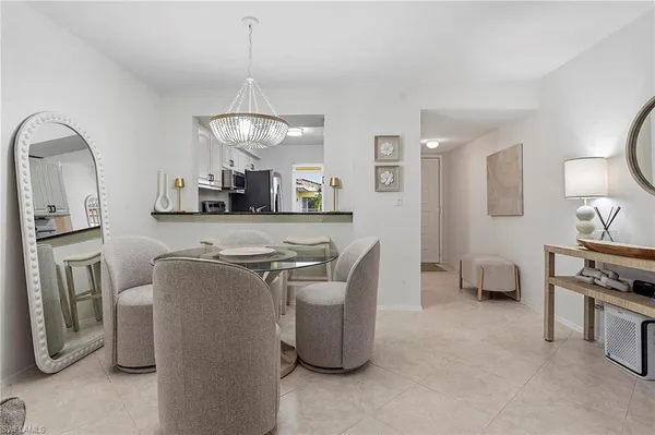 a living room with furniture a window and kitchen view