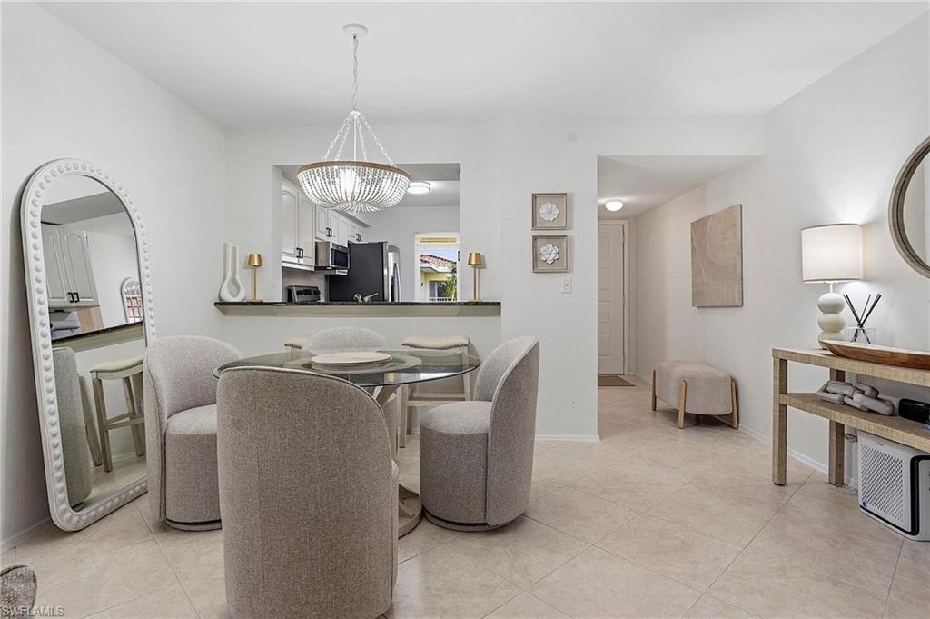 1001 Foxfire Lane, Unit 307 Naples, FL 34104 - Photo 5 of 23 a living room with furniture a window and kitchen view