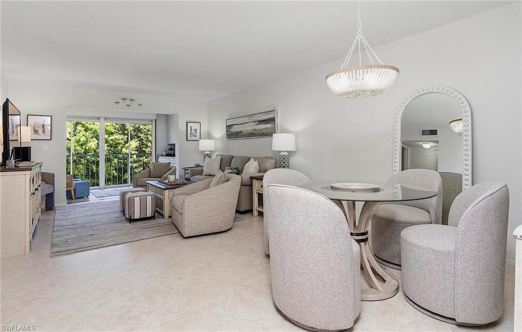 1001 Foxfire Lane, Unit 307 Naples, FL 34104 - Photo 6 of 23 a living room with furniture and a large window