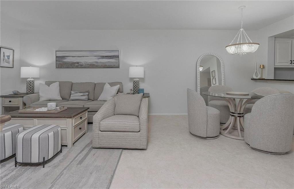 1001 Foxfire Lane, Unit 307 Naples, FL 34104 - Photo 7 of 23 a living room with furniture a sink and a table