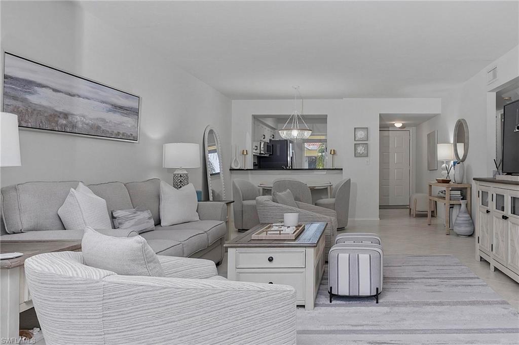 1001 Foxfire Lane, Unit 307 Naples, FL 34104 - Photo 10 of 23 a living room with furniture and wooden floor