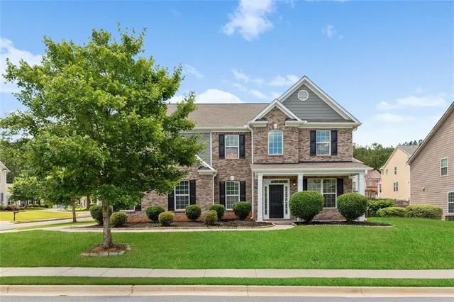 a front view of a house with a yard