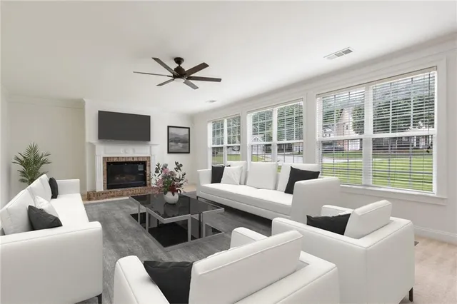 a living room with furniture large windows and a fireplace