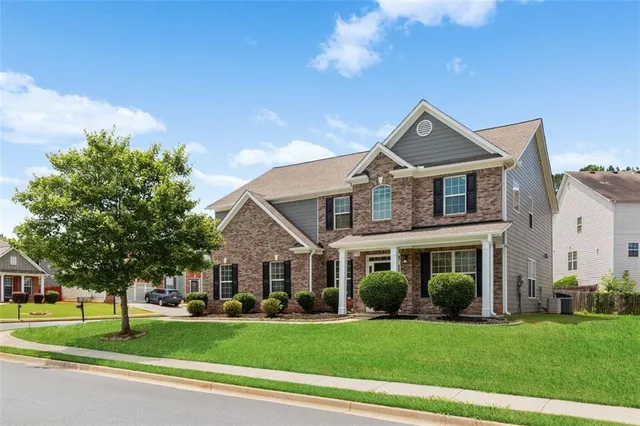 a front view of a house with a yard